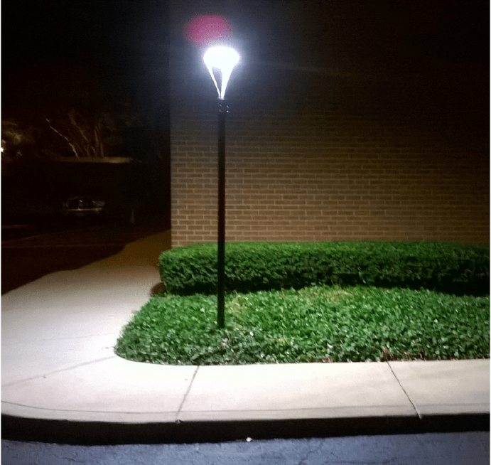 Bright solar powered lamp lighting the sidewalk